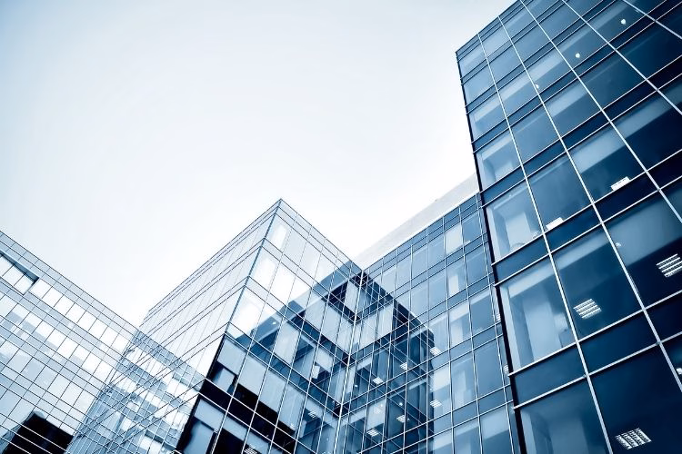 Modern glass office buildings representing corporate business, commercial real estate, and professional services.